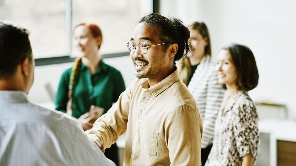 Man shaking hands with colleague