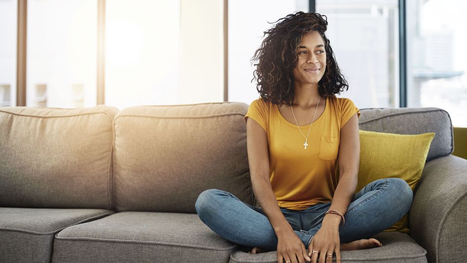 Woman sitting on the couch in her home