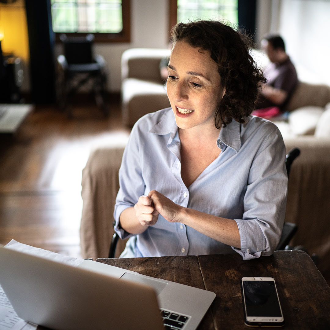 disabled woman in an online meeting talking about inclusive employee benefits