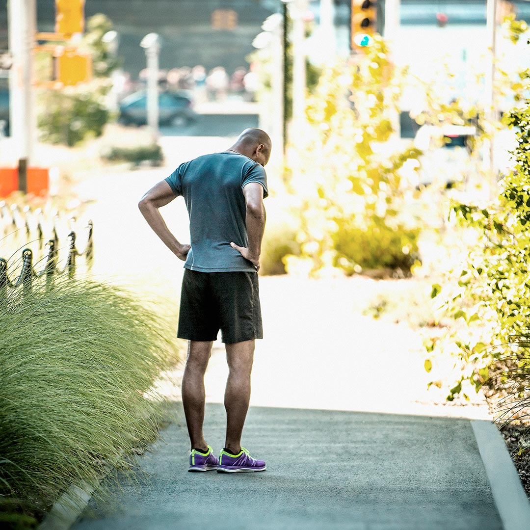 Man pauses during outdoor run