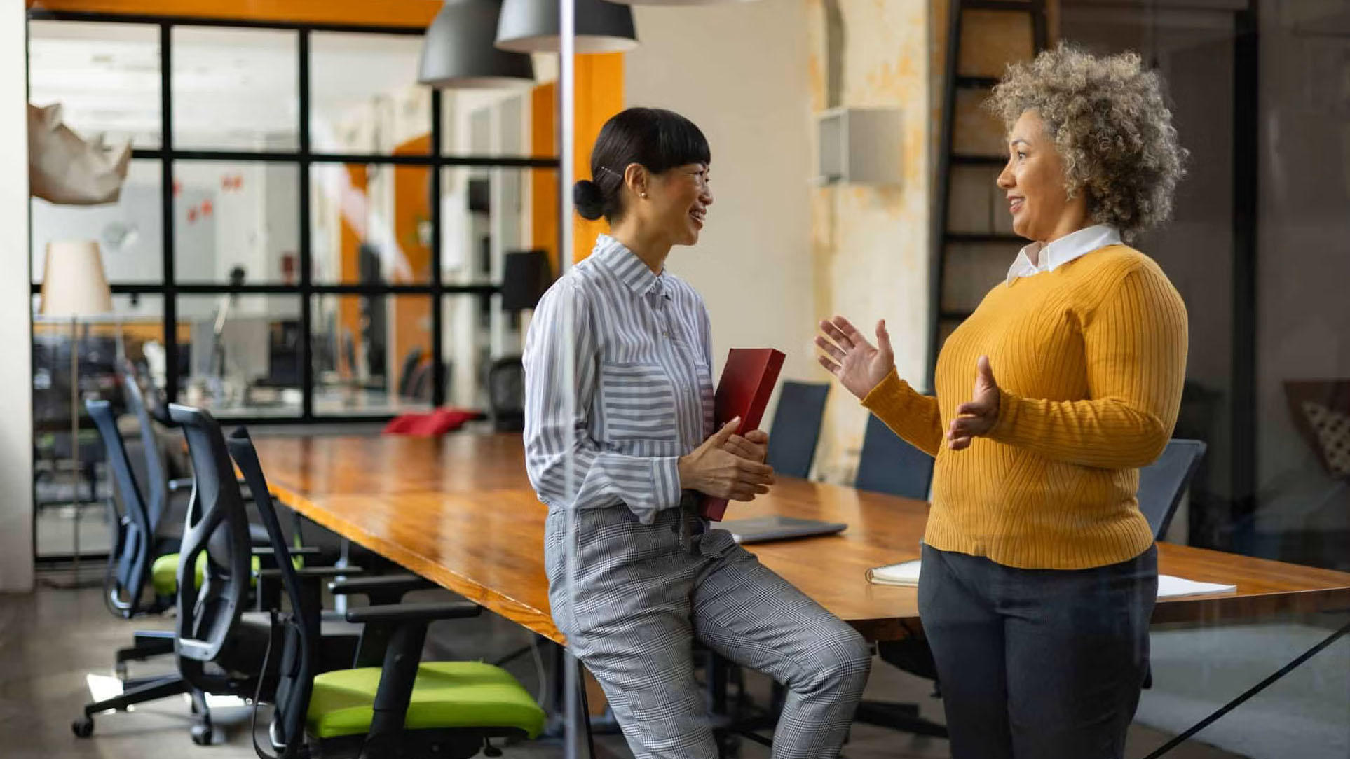 ladies in office discussing benefits administration