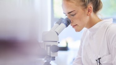 woman using microscope