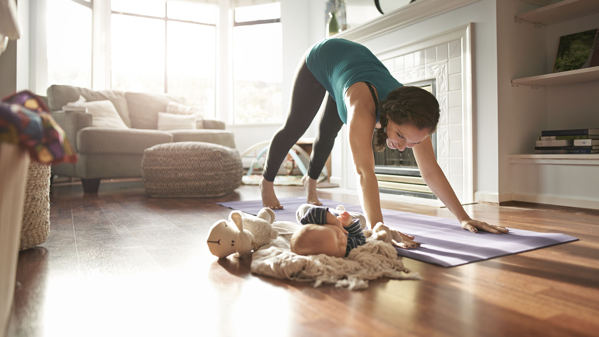 mother does yoga with baby beside her - while she is on a leave of absence for work