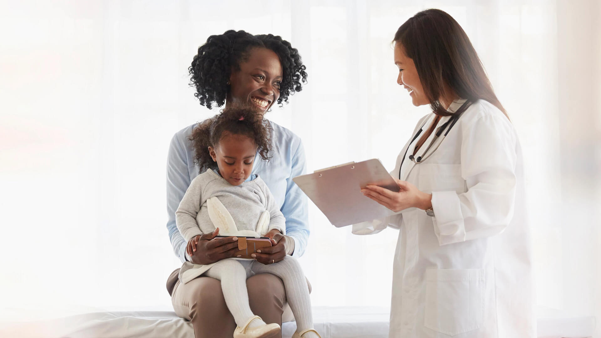 mother and toddler talking to doctor